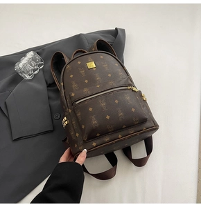 Detail of vintage dark brown backpack with cartoon rabbit patterns and sturdy zippers