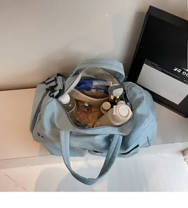 Top view of blue nylon travel bag showing spacious interior with bottles and pouches