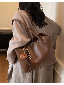 Brown large leather tote bag with bear charm and dual straps for women's casual fashion