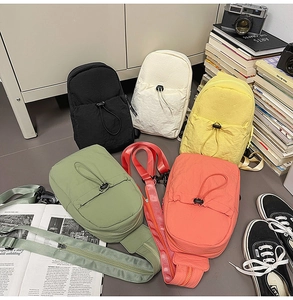Assorted pastel nylon chest bags in black, beige, yellow, green, and pink with drawstring details