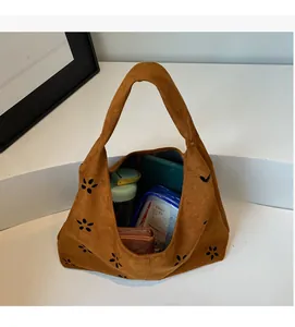 Macro shot of brown suede tote bag showing large capacity for phone and wallet