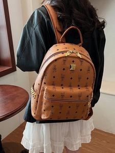 Brown leather backpack with rabbit prints and golden hardware in a stylish commute style