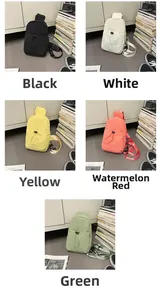 Close-up of lightweight nylon sling bags in black, white, yellow, red and green colors
