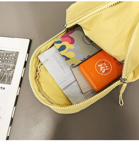 Macro view of spacious main compartment in yellow nylon backpack with zipper closure