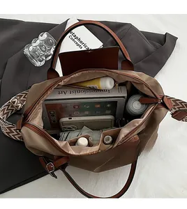 Internal view of spacious khaki nylon tote bag showing tablet and travel essentials