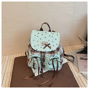 Detail of plaid backpack with mint green star print flap and cute brown ribbon bows