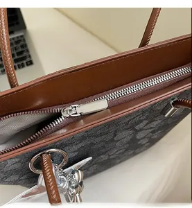 Detail of silver smooth zipper and classic vintage pattern on spacious tote bag