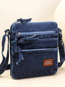 Retro washed denim crossbody bag in dark blue with multiple pockets and zipper design