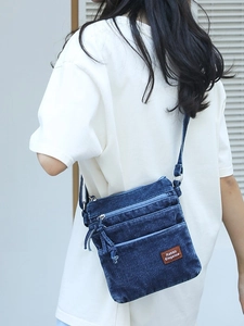 Retro washed denim crossbody bag with multiple zip pockets and adjustable shoulder strap
