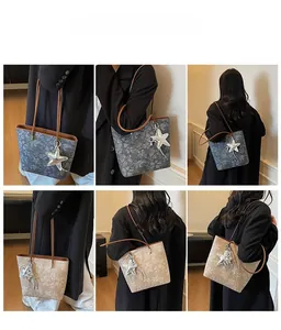 Floral print tote bag in dark grey and beige with star pendant shown on a model