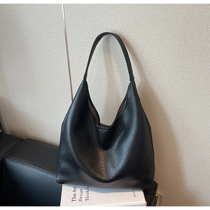 Close-up of black textured leather tote bag with large capacity for office commute