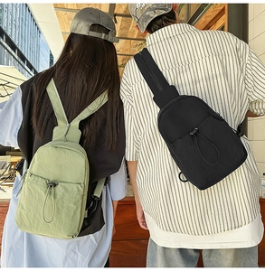 Outdoor lifestyle shot showing light green and black nylon chest bags on models