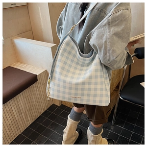 Dettaglio della borsa tote a quadretti blu con scritta Fashion & Bags su tela leggera
