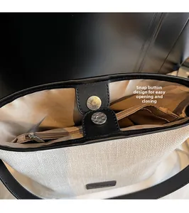 Dettaglio borsa a tracolla intrecciata con chiusura magnetica e tasca interna zip