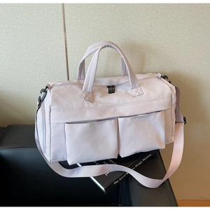 Detail of light purple nylon travel bag with reinforced handles and adjustable strap
