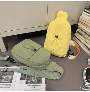 Detail of yellow and green nylon sling bags with elastic drawstring and adjustable straps