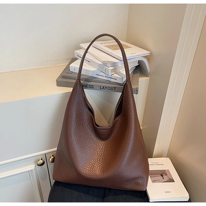 Close-up of a large dark brown hobo bag featuring premium pebble-grain leather texture