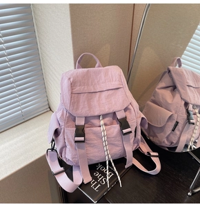 Detail of lavender nylon backpack featuring buckle closure and natural crinkled texture