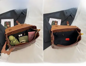 Detail view of large main compartment in brown vintage leather bag showing storage capacity