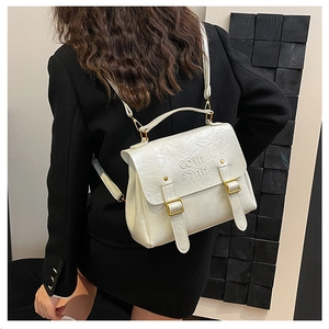 Detail of off-white vintage pleated texture backpack with COIN COIN embossed buckle