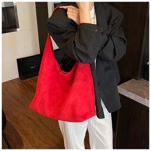 Model wearing large red matte suede hobo tote bag for vintage autumn winter style