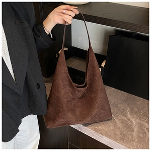 Close-up of a large brown matte suede hobo bag showing its soft texture and capacity