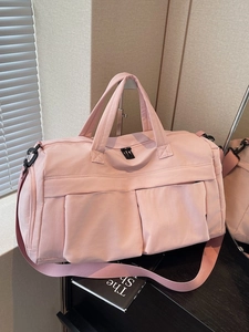 Pink waterproof nylon travel bag with dual handles and adjustable shoulder strap for gym