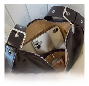 Interior view of leather hobo bag showing spacious capacity for phone and perfume