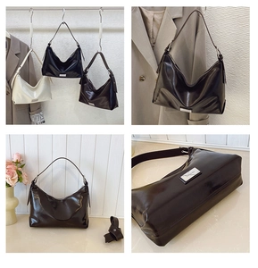 Detail shot of vintage shiny leather underarm bags in black, cream, and coffee brown colors