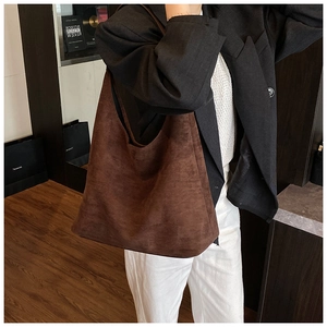 Deep brown suede Hobo bag shown on a model with minimalist modern office attire