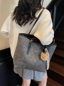 Deep grey tote bag with vintage texture and teddy charm for stylish daily commuting
