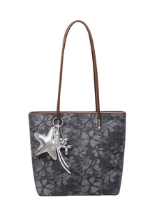 Floral print tote bag in dark gray with brown straps and star and balloon dog charms