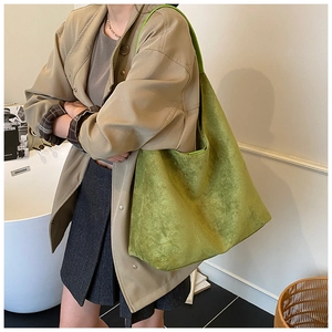 Green velvet hobo bag detail showing the soft suede texture and large tote capacity