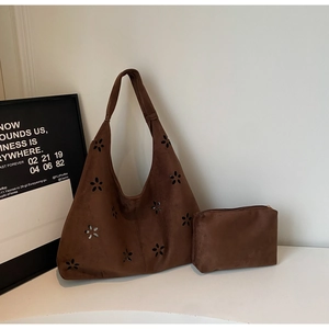 Close-up of hollow flower pattern on dark brown matte suede hobo bag with coin purse