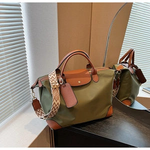 Detailed shot of large nylon tote bag with leather flap and geometric patterned strap
