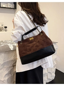 Vintage retro brown suede tote bag with chain strap and quilted pattern shown on model