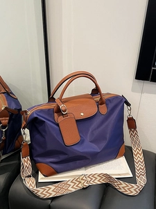 Purple nylon tote bag with brown leather accents and geometric woven shoulder strap