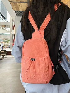 Versatile coral orange nylon backpack with adjustable zipper straps for men and women