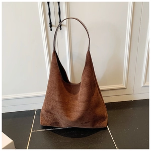 Detail of vintage brown suede tote bag featuring high-quality matte texture and shoulder strap