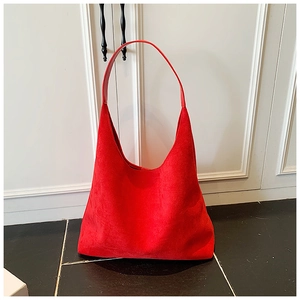 Detail of red matte suede hobo bag showing its large capacity and integrated leather strap