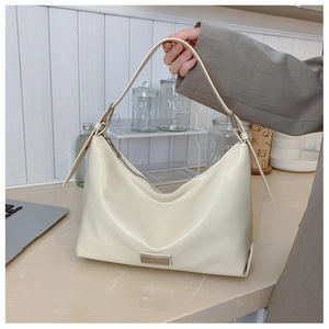 Detailed view of cream white PU leather hobo bag with sleek metal logo plaque and zipper