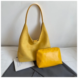 Detail view of yellow frosted leather tote bag set with matching zipper pouch clutch
