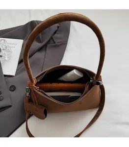 Detailed interior of a brown suede shoulder bag showing large storage capacity