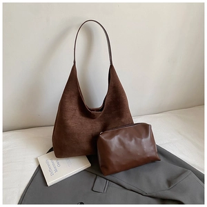Deep brown matte suede tote bag with matching leather inner pouch on a grey blazer background