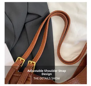 Close-up of brown pebbled leather bucket bag with gold buckle and adjustable strap