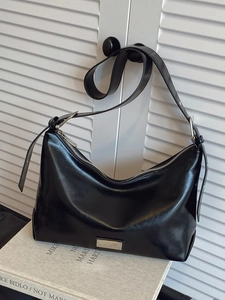 Glossy black crescent underarm bag with silver metallic detail and adjustable strap