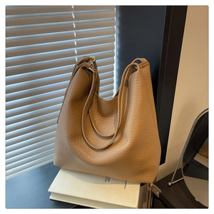 Close-up of the brown pebbled leather texture on the large minimalist tote bag