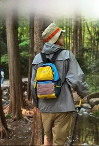 Close-up of hiking backpack showing colorful nylon fabric and elastic storage cords