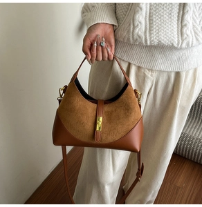 Detail of suede and smooth leather stitching bag with gold twist lock and handle