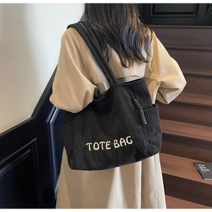 Détail du grand sac cabas en velours côtelé noir avec broderie blanche en relief